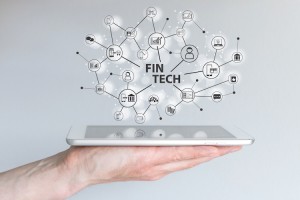 Fin Tech and mobile computing concept. Hand holding tablet